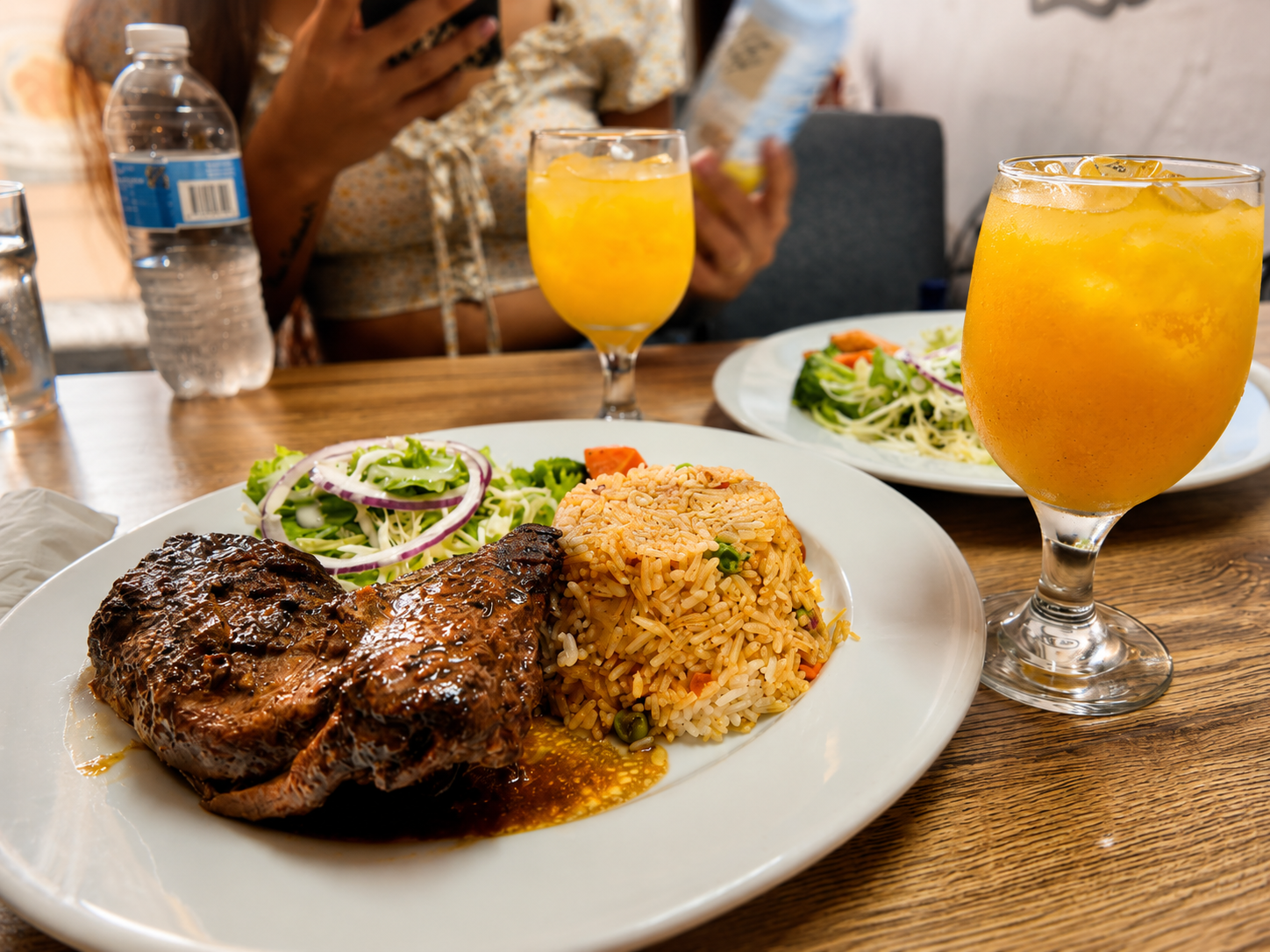 Grilled steak with seasoned rice, salad and fresh passion fruit juice
